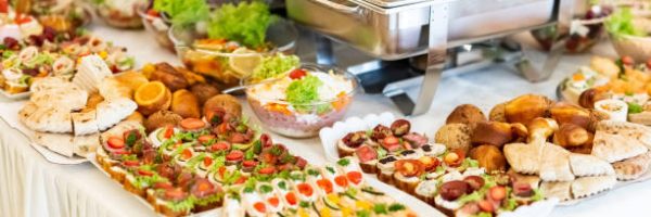 Catering buffet table with canapes, salads and bread.