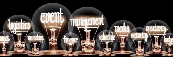 Photo of light bulbs group with shining fibers in a shape of Event Management, Logistics, Target, Creativity and Media concept related words isolated on black background