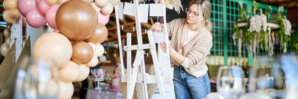 Female party decorator arranging decorations for a child birthday party