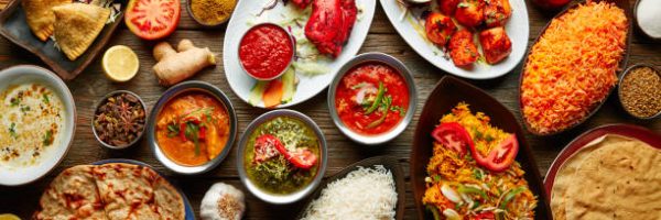 Assorted Indian recipes food various with spices and rice on wooden table