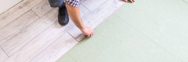 worker-processing-floor-with-bright-laminated-flooring-boards_231208-4213